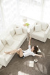 © Blue Jean Images - Cheerful young Chinese woman relaxing at home