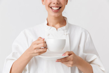 Wall Mural - Cropped image of a cheerful young woman cook