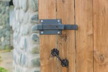 Close Up Of Wooden Door With Metal Latch Lock