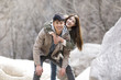 © Blue Jean Images - Portrait of happy young Chinese couple outdoors in winter