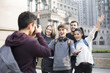 © Blue Jean Images - Cheerful abroad students taking photos on campus