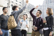 © Blue Jean Images - Cheerful abroad students high fiving on campus