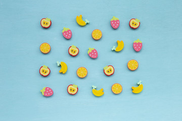 Colorful design fruit shape rubber on blue texture background, cute eraser design background