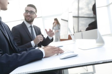 Poster - business colleagues sitting at their Desk