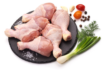 Raw chicken legs with spices, isolated on white background.