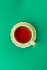 Wall Mural - green cup of tea on green tablecloth