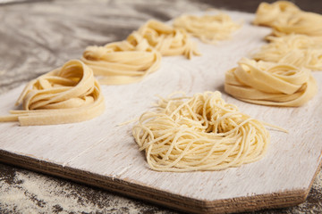 Wall Mural - Raw tagliatelle nest on kitchen table