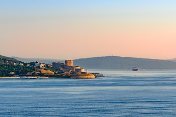 Entrance to Dardanelles (Canakkale strait) in morning haze from Aegean Sea with Ottoman fortress Kilitbahir ahead