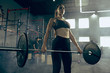 © master1305 - Fit young woman lifting barbells working out in a gym