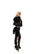 © faestock - full length portrait of blonde girl wearing lack fantasy warrior outfit. standing pose wit bak to the camera. isolated on white studio background.