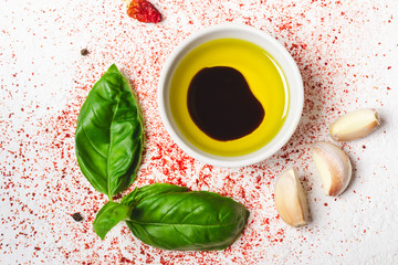 Olive oil and spices on a white background closeup