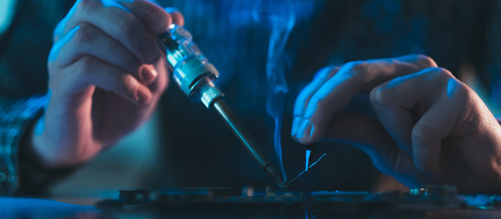 computer hardware engineering. technology science concept. developer soldering electronic component