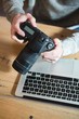 © Wavebreak Media - Man using digital camera at home