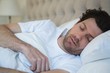 © Wavebreak Media - Man sleeping in bedroom
