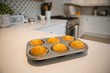 © Wavebreak Media - Muffins in baking tray at home