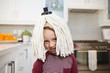 © Wavebreak Media - Happy boy with mop on head in kitchen