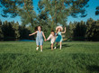 © rotozey - little kids playing around on the lawn. two girls and a boy