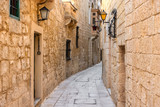 Fototapeta Uliczki - beautiful view of ancient narrow medieval street town Mdina, Malta