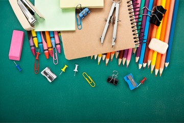 Poster - Colorful school supplies on wooden table background