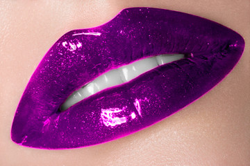 Sexual chubby female lips close-up. Violet lipstick on lips. Fashionable creative cosmetics during the Halloween