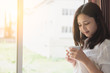 © AePatt Journey - Morning wake up with coffee. Young asian woman holding a cup of coffee or tea.