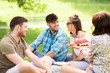 © Syda Productions - friendship, leisure and summer concept - group of happy friends eating watermelon at picnic in park