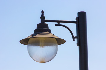 old vintage lantern against blue sky background