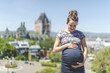 © Louis-Photo - Portrait of a happy and proud pregnant woman on urban background