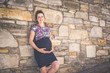 © Louis-Photo - Portrait of a happy and proud pregnant woman on urban background