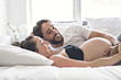 © Louis-Photo - Man with pregnant woman in bed at home having great time
