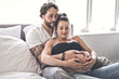 © Louis-Photo - Man with pregnant woman in bed at home having great time
