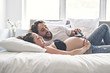 © Louis-Photo - Man with pregnant woman in bed at home having great time
