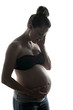 © Louis-Photo - Pregnant woman against the light concept