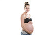 © Louis-Photo - pregnant woman caressing her belly over white background