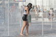 Girl bathe in the fountain in hot summer day