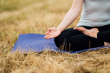 Close up hands. Woman do yoga outdoor. Woman exercising vital and meditation for fitness lifestyle club at the nature background. Healthy and Yoga Concept