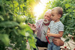 © ivanko80 - Grandfather and his grandson in a greenhouse