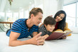 © tool51 - family being playful at home , child at home reading a book for relaxing