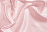 Fototapeta  - The texture of the satin fabric of pink color for the background 