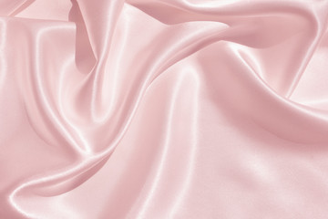 the texture of the satin fabric of pink color for the background