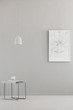 © Photographee.eu - Pendant light above a modern table and a city map poster on a gray wall in a minimalist living room interior and place for a sofa. Real photo.
