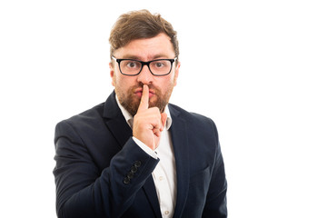 Wall Mural - Portrait of business man making silence gesture.