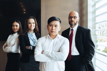 Wall Mural - Group portrait of a professional business team looking confidently at camera