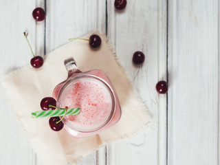 Wall Mural - Cherry refreshing cocktail or smoothie on wooden table top view
