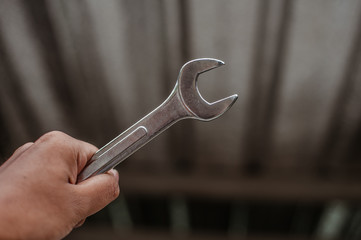 a man hold wrench.the concept of automotive, repairing, mechanical, vehicle and technology.