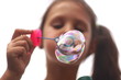 © taraskobryn - young girl blowing bubbles blurry