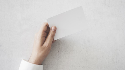 Hand holding a blank business card