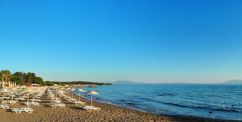 turkey aegean sea coast. sunbeds and umbrellas on the beach