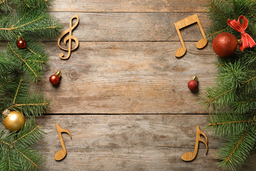 Flat lay composition with decorations and  notes on wooden background. Christmas music concept