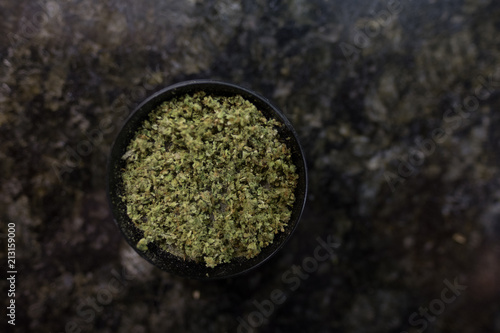 Marijuana grinder - isolated - space for text - with freshly ground marijuana in Tableau sur Toile